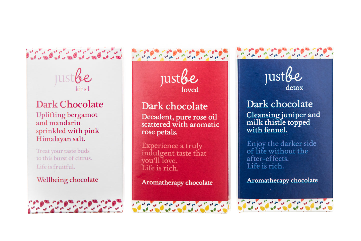 Three JustBe Botanicals dark chocolate bars with different packaging, indicating various flavors within the collection.