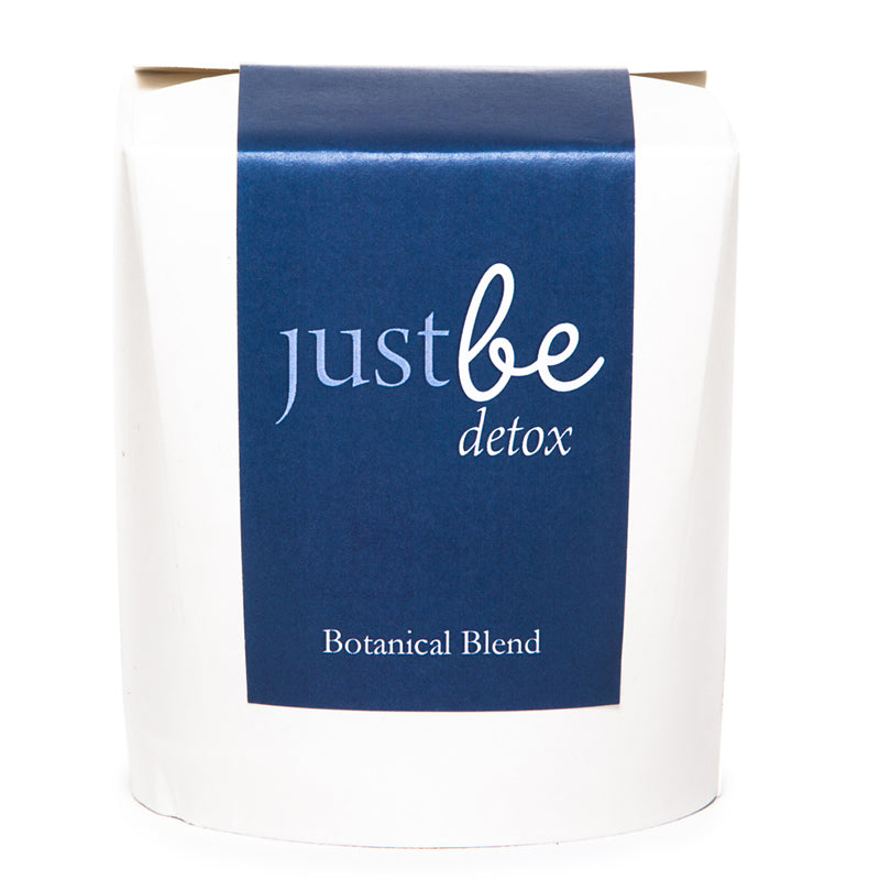 JustBe Detox herbal tea in a white box with a deep navy label. Botanical blend designed to support natural cleansing with cleavers, elderberries & hibiscus.