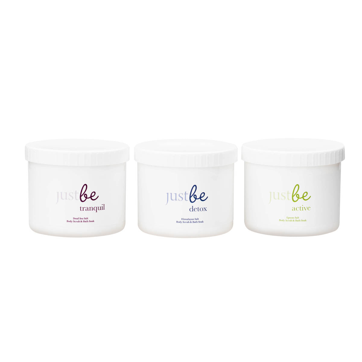 Three white tubs of JustBe bath salts. From left to right: JustBe Tranquil Dead Sea Salt, JustBe Detox Himalayan Salt, and JustBe Active Epsom Salts. Set against white background.