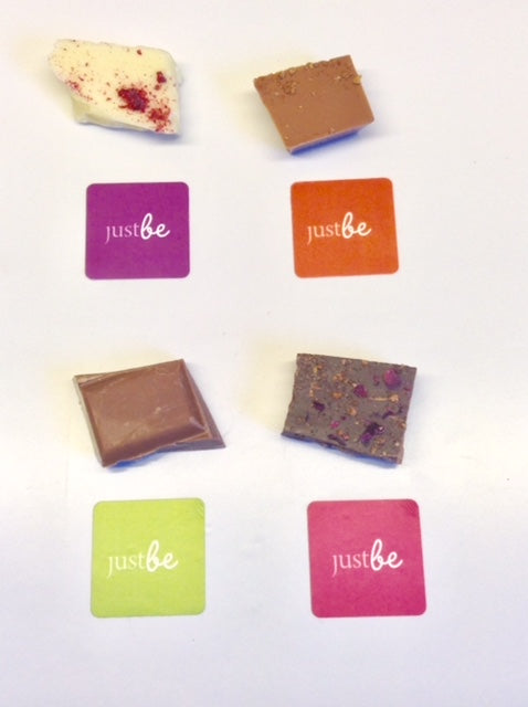 4 shares of chocolate on a white back ground with JustBe coloured stickers