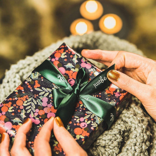 Christmas Gift with green JustBe ribbon being opened