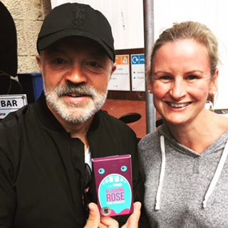 Gail Bryden standing beside Graeme Norton holding a bar of JustBe Edinburgh Fringe Chocolate