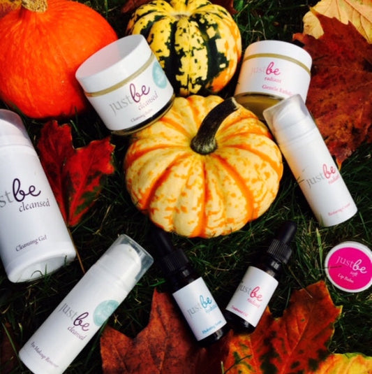JustBe Botanicals facial range on top of colourful pumpkins