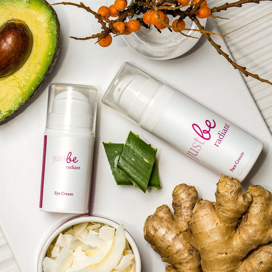 JustBe Botanicals Radiant Eye Cream and Face Cream with natural ingredients including avocado, aloe vera, ginger, sea buckthorn, and coconut flakes.