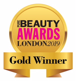 JustBe Botanicals Gold winner badge from the Pure Beauty Awards London 2019, featuring a gold medal design with pink and black text.