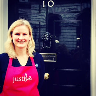 Gail Bryden founder of JustBe Botanicals outside no.10 Downing Street front black door as part of small business Saturday