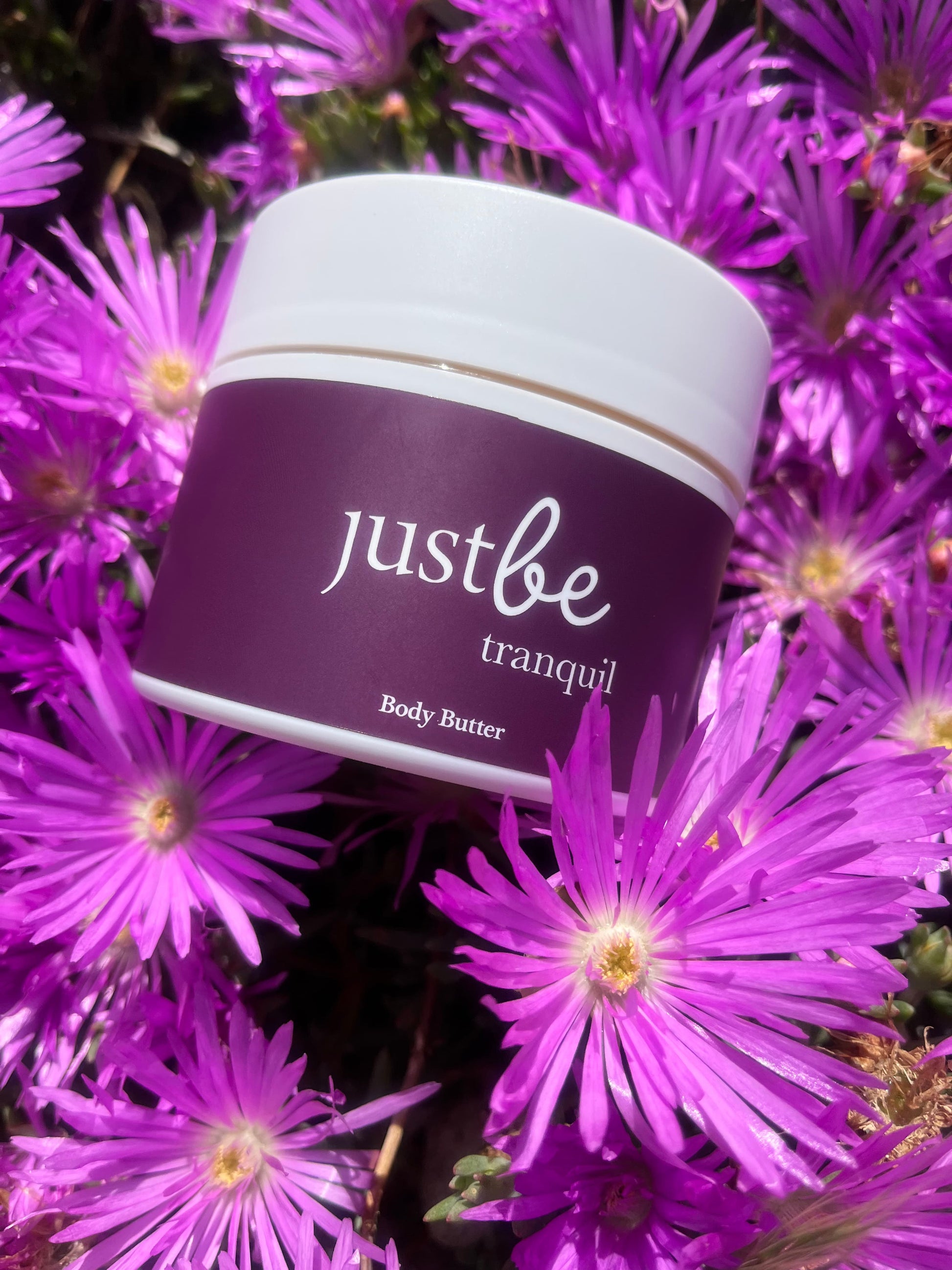 JustBe Botanicals Aromatherapy Tranquil Body Butter in flowers