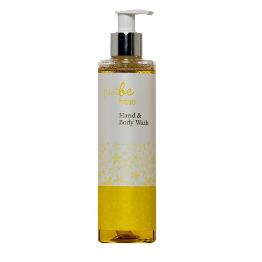 A pump bottle of JustBe Botanicals Happy Hand & Body Wash with a yellow liquid visible through the transparent bottom section, labeled 'Just Be happy'.