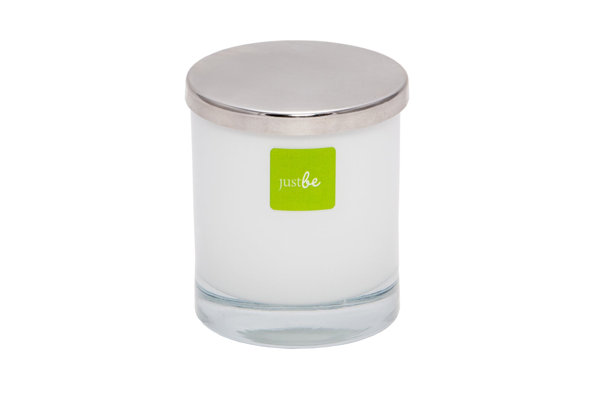 Glass candle with a silver lid and green 'just be' label on a white background