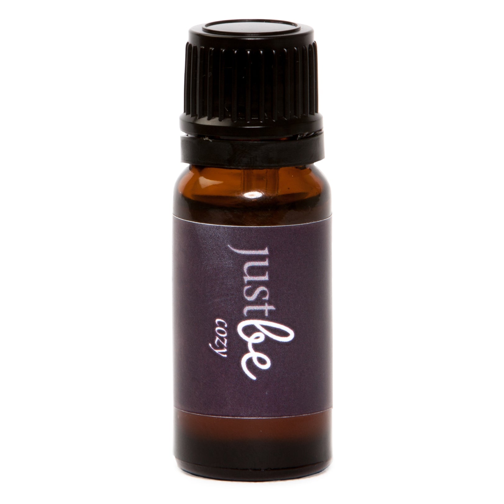 Amber glass bottle of JustBe Cozy essential oil blend with a dark purple label and black cap