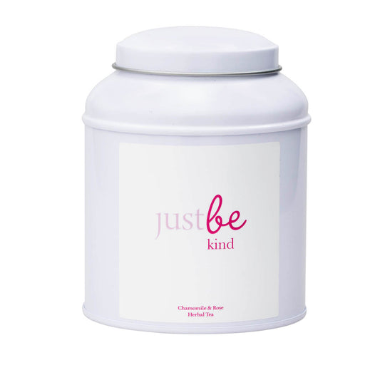 A white metal container of herbal tea with the brand name JustBe Kind and 'Chamomile & Rose' on white  label