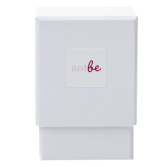 White box with a white square label reading "justbe" in blush pink text – packaging for JustBe Kind Inspiration Cards which are typically used for inspiration or guidance.