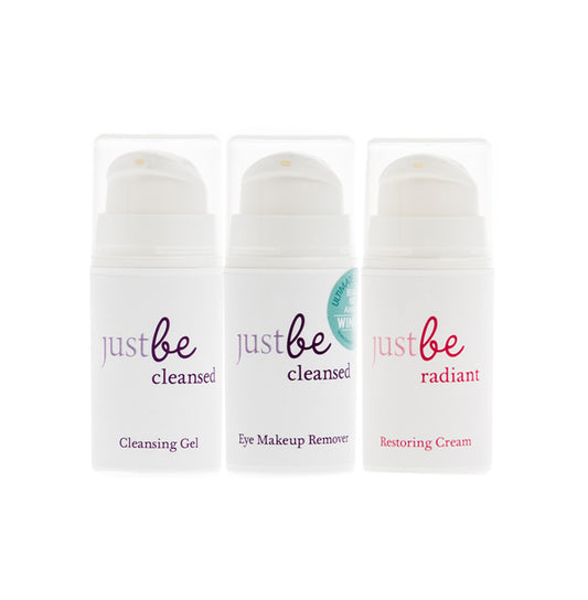 JustBe Botanicals travel size skincare trio featuring Cleansing Gel, Eye Makeup Remover, and Restoring Cream in white 15ml pump bottles.